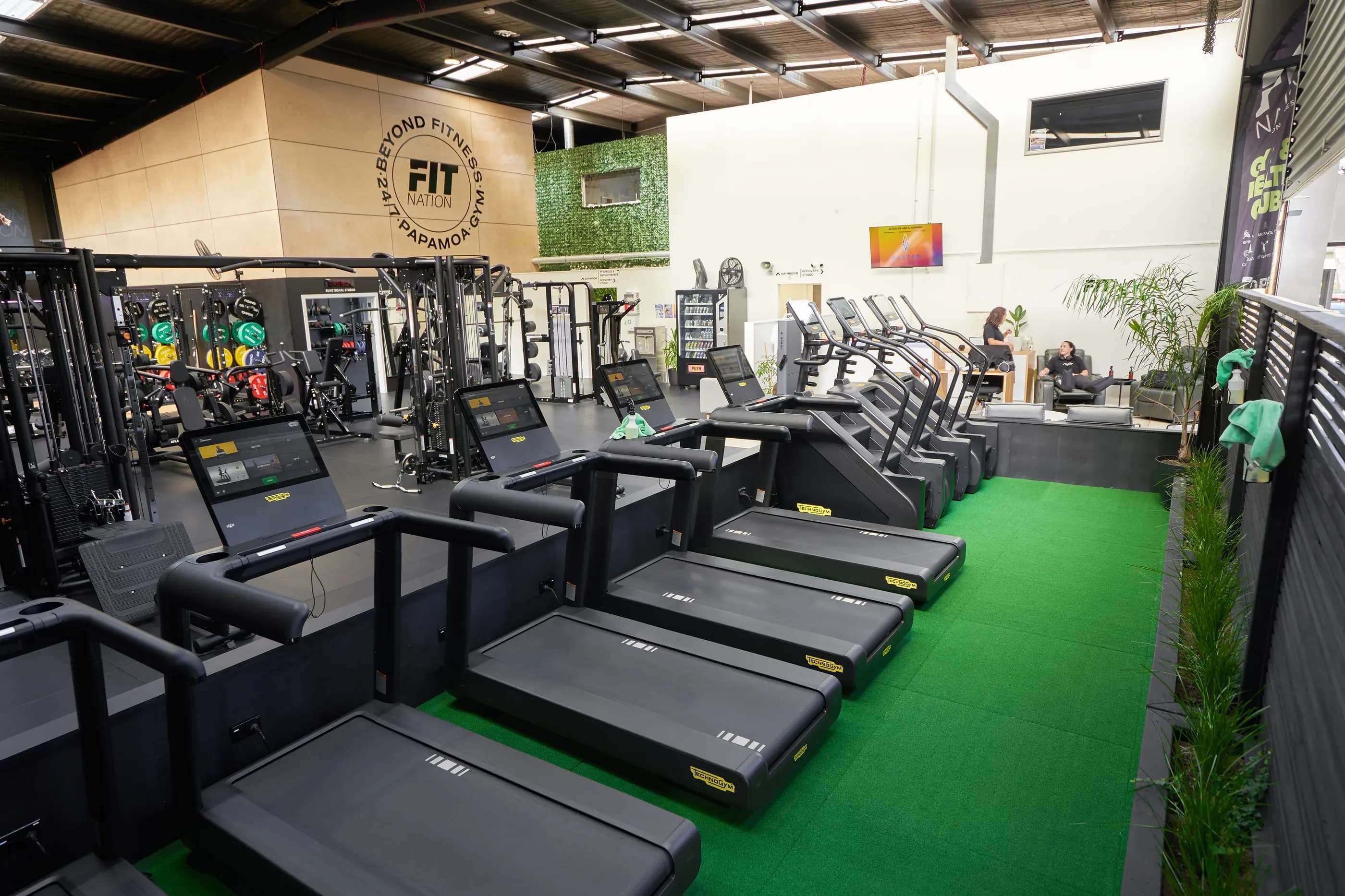Treadmills beside the turf track on the main gym floor at Fit Nation Papamoa